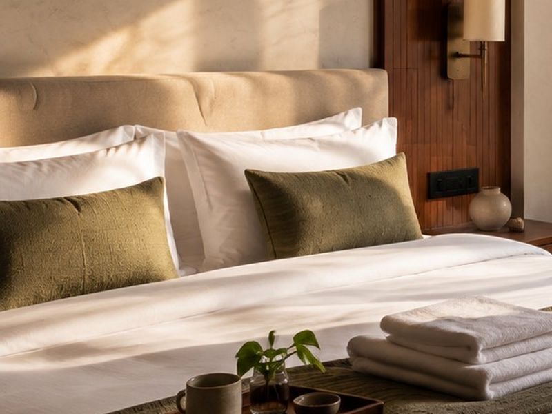 Made for rest: Crisp linen and soft olive cushions.